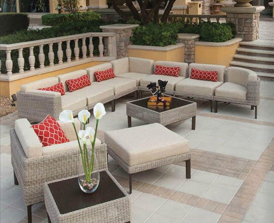 Luxurious patio with large sectional and coffee tables