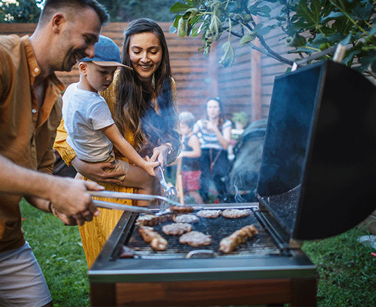 Family cooking on grill