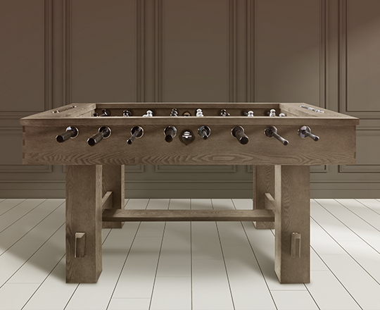 Grey foosball table on beige background