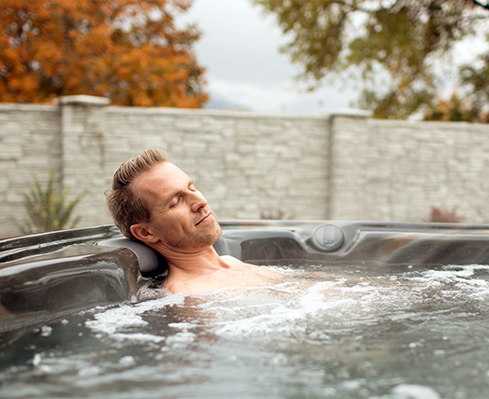 Man relaxing in spa outdoors