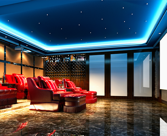 Red home theatre seats in modern basement with surreal lighting