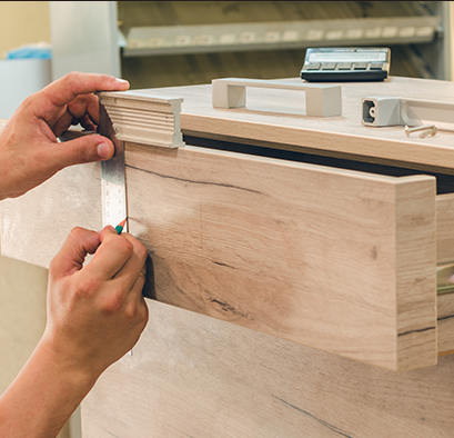 Closeup of woodworker building a wood drawer in a table