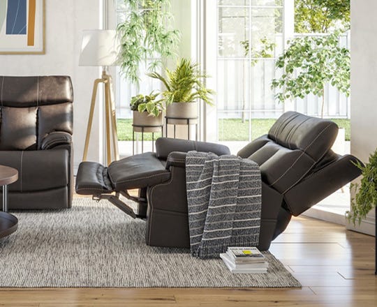 Transitionally styled brown reclining sofa in living room