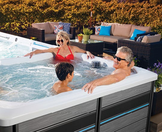 People relaxing in a spa on a patio