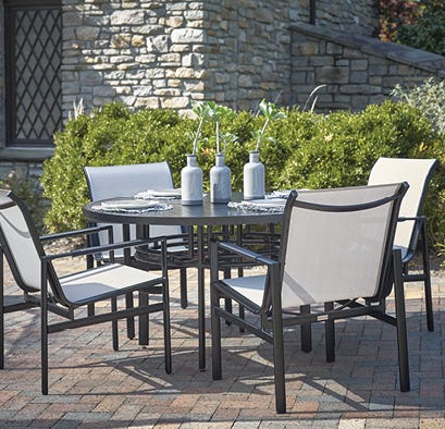 Outdoor dining set on a brick patio