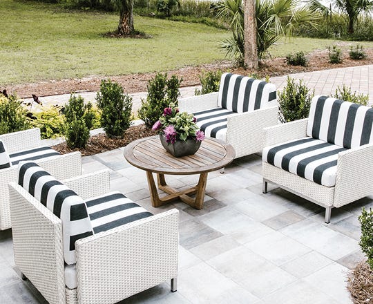 Outdoor seating area on a patio with table and 2 chairs
