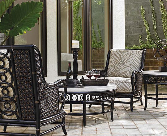 Outdoor seating area on a patio with table and 2 chairs