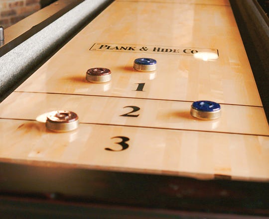 shuffleboard tables with pucks on it