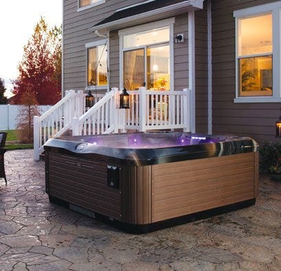 Bullfrog spa with purple lighting and wood panels